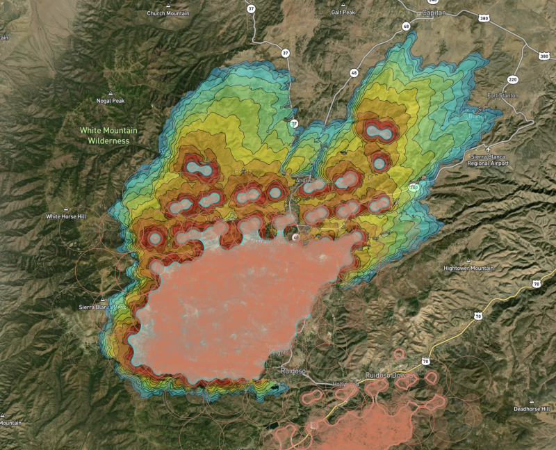 An example of Wildfire Solution in action during wildfires outside of the town of Ruidoso, New Mexico. Fire detections and clusters are shown in orange, while a 12-hour Fire Spread simulation is shown with the colored lines. 